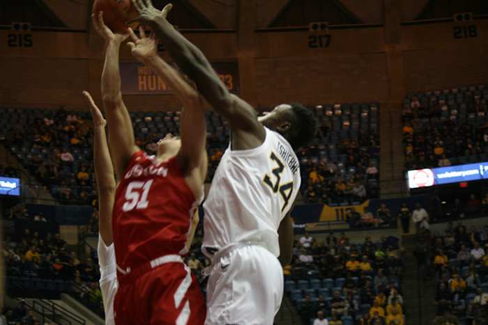 West Virginia forward Oscar Tshiebwe with a block on Bostons Max Mahoney inside the WVU Coliseum on Friday night in the second round of the Cancun Challenge.